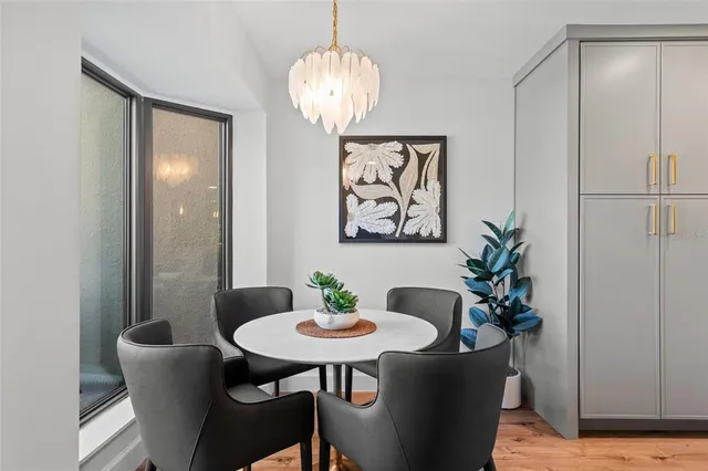 a view of a dining room with furniture wooden floor and a chandelier