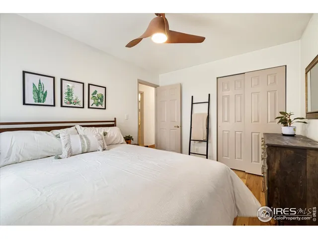 a spacious bedroom with a large bed and a chandelier