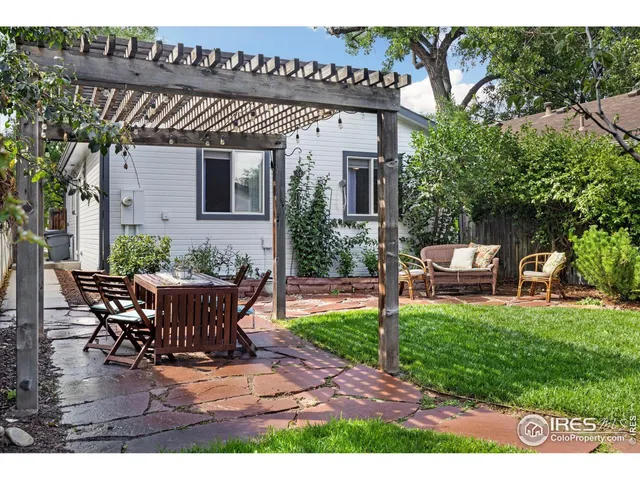 a view of a patio with table and chairs and potted plants