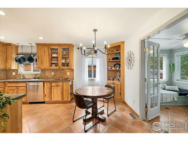 a very nice looking dining room with kitchen island furniture and a chandelier