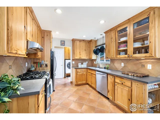 a kitchen with stainless steel appliances kitchen island granite countertop a stove a sink and a microwave