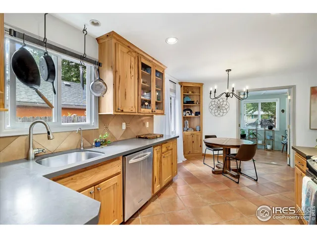 a kitchen with stainless steel appliances granite countertop a sink a stove and a microwave