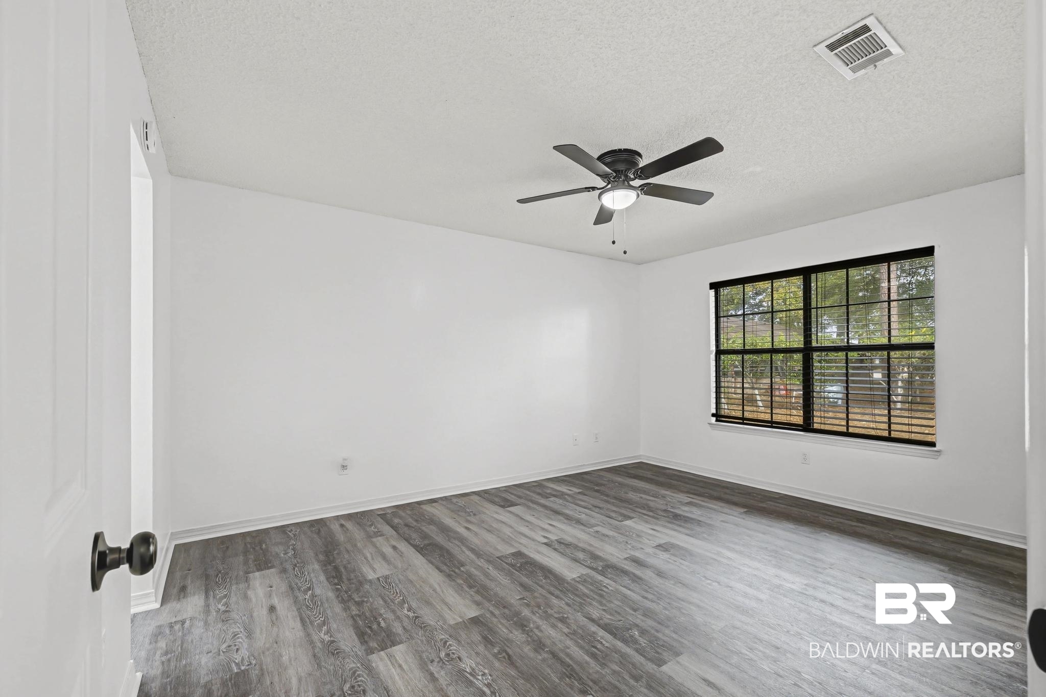 2776 Santa Rosa Circle Lillian, AL 36549 - Photo 22 of 48 Spare room with wood finished floors, a textured ceiling, and a ceiling fan
