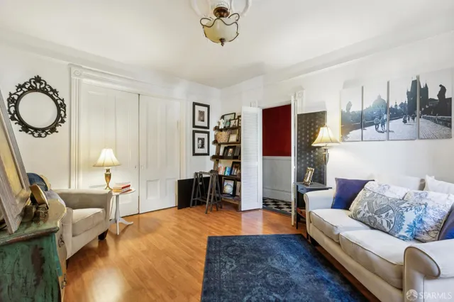 a view of a hallway with wooden floor and entryway