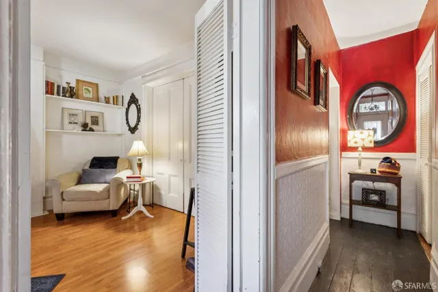 a bedroom with a bed and painting on the wall