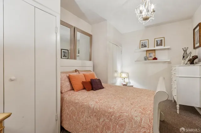 a view of a hallway with wooden floor and windows