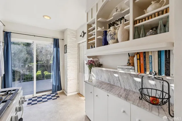 a kitchen with stainless steel appliances granite countertop a stove a refrigerator and a wooden cabinets