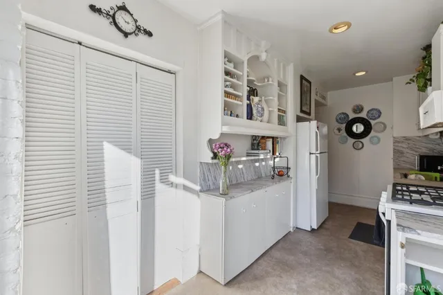 a kitchen with a stove and a refrigerator