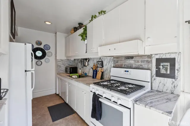 a balcony with wooden floor and potted plants