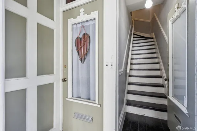 a bedroom with furniture and a rug