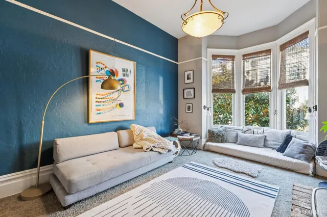 a bedroom with a bed and a painting on the wall