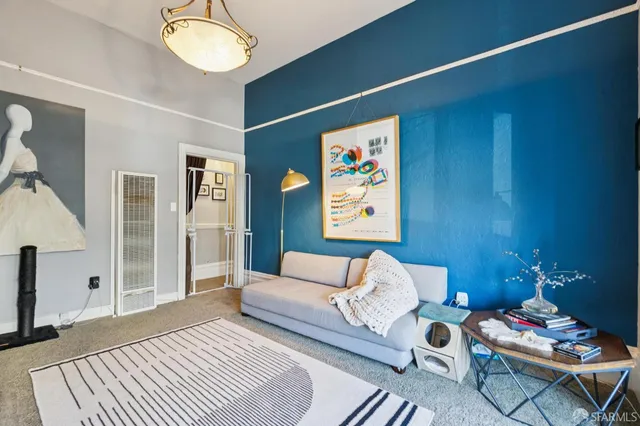 a bedroom with a bed and painting on the wall