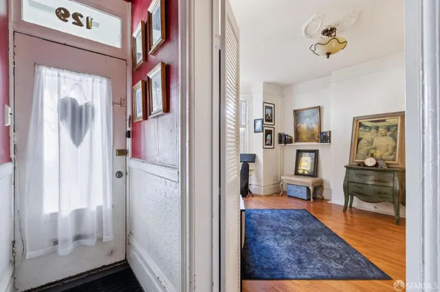 a living room with furniture fireplace and a window
