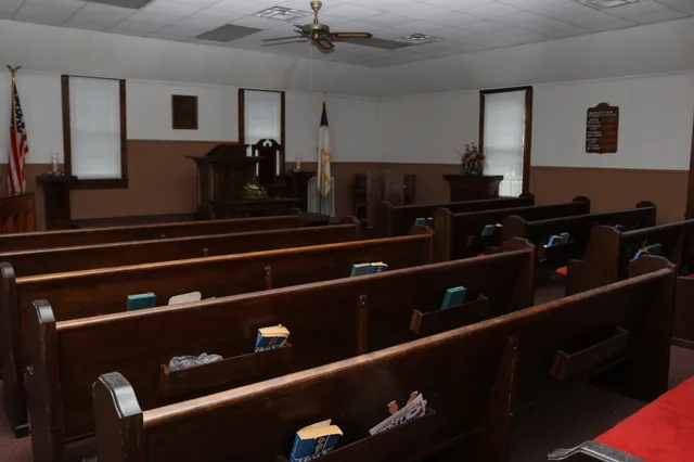 a black leather couch sitting inside of a kitchen
