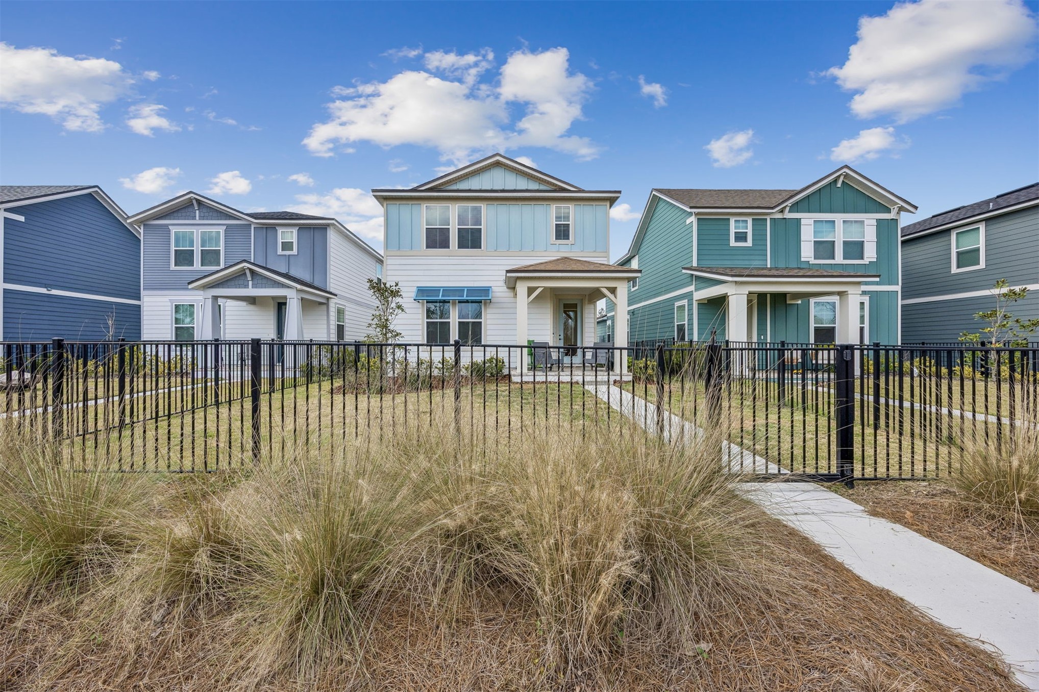 236 Hawthorn Park Circle Yulee, FL 32097 - Photo 2 of 28 a view of a white house with a large windows next to a yard