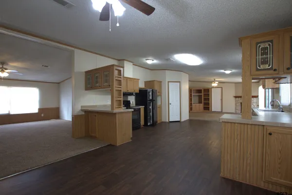 a kitchen with stainless steel appliances kitchen island granite countertop a refrigerator and a stove top oven