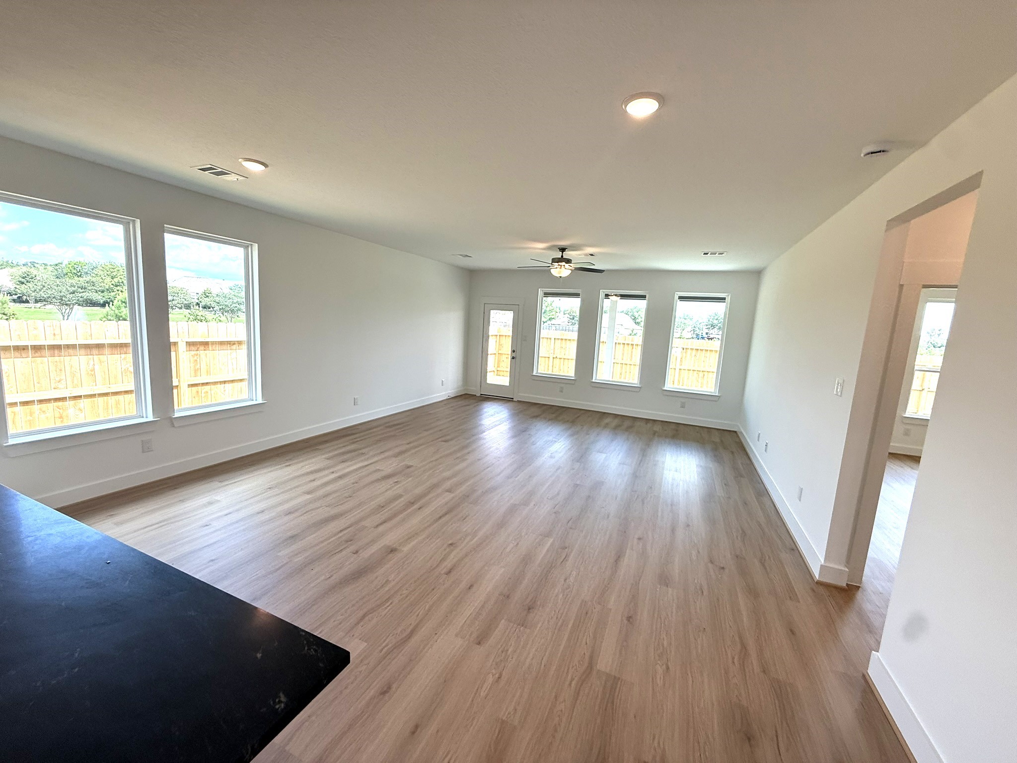 5314 Grace Sunshine Spring Spring, TX 77379 - Photo 7 of 23 Imagine walking into a home that feels as expansive as it is inviting, bathed in natural light and framed by soaring ceilings that make every moment feel grand.