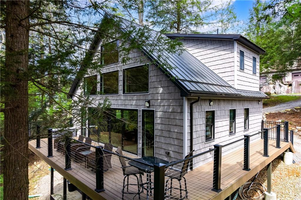 a front view of house with deck and outdoor seating