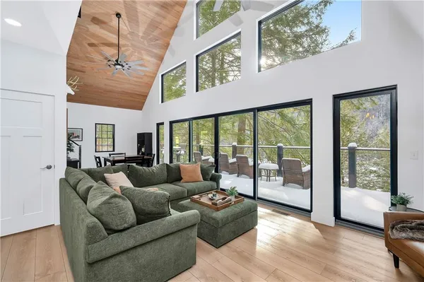 a living room with furniture and large windows