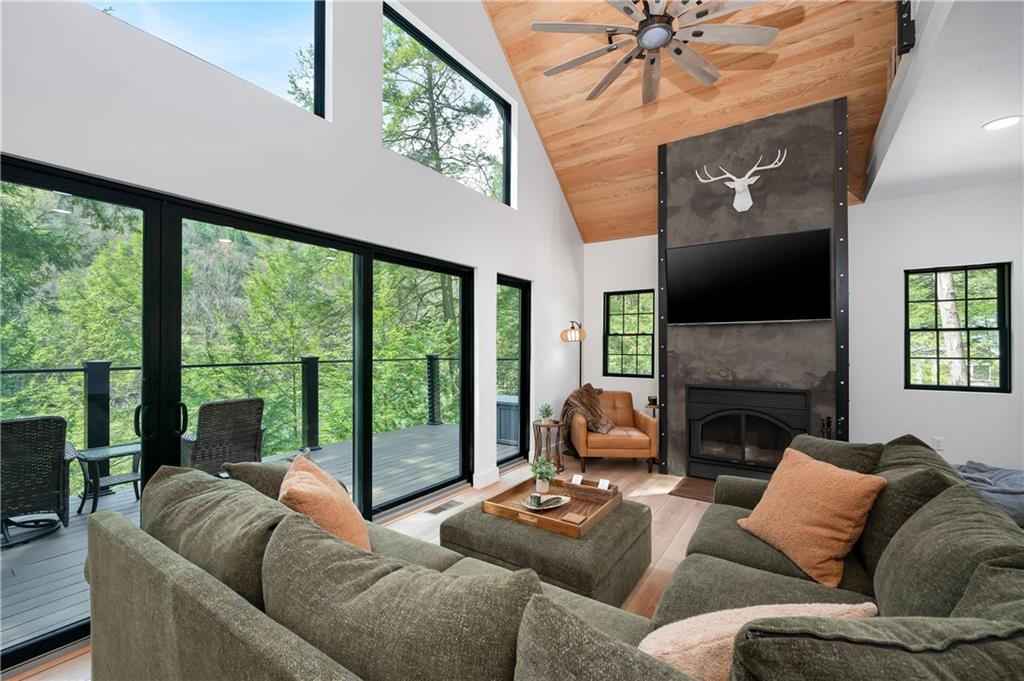 162 East Maple Lane Clarion, PA 16214 - Photo 16 of 49 a living room with furniture a large window and a fireplace