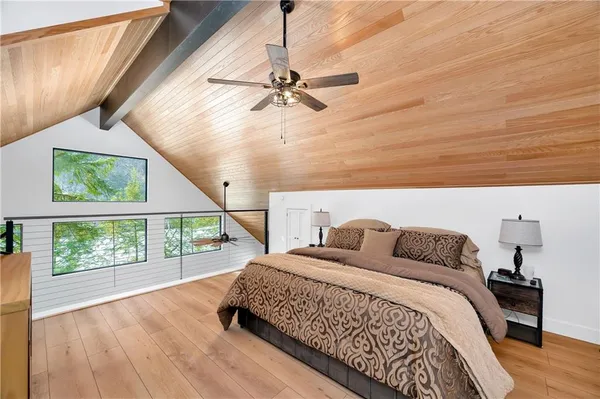 a bedroom with a bed and a large window