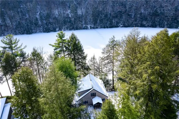 a view of house with tall trees