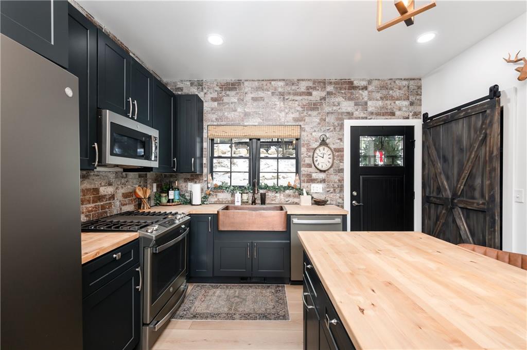 162 East Maple Lane Clarion, PA 16214 - Photo 8 of 49 a kitchen with stainless steel appliances granite countertop wooden cabinets a stove top oven a sink and dishwasher