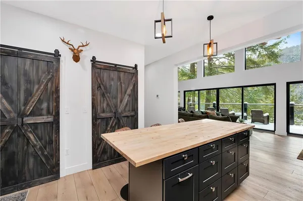 a kitchen with a wooden floor and a dining table