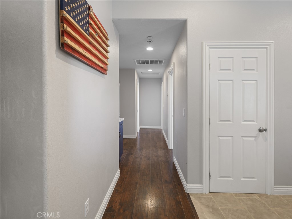 7755 7th Street Phelan, CA 92371 - Photo 11 of 27 a view of a hallway with wooden floor and closet