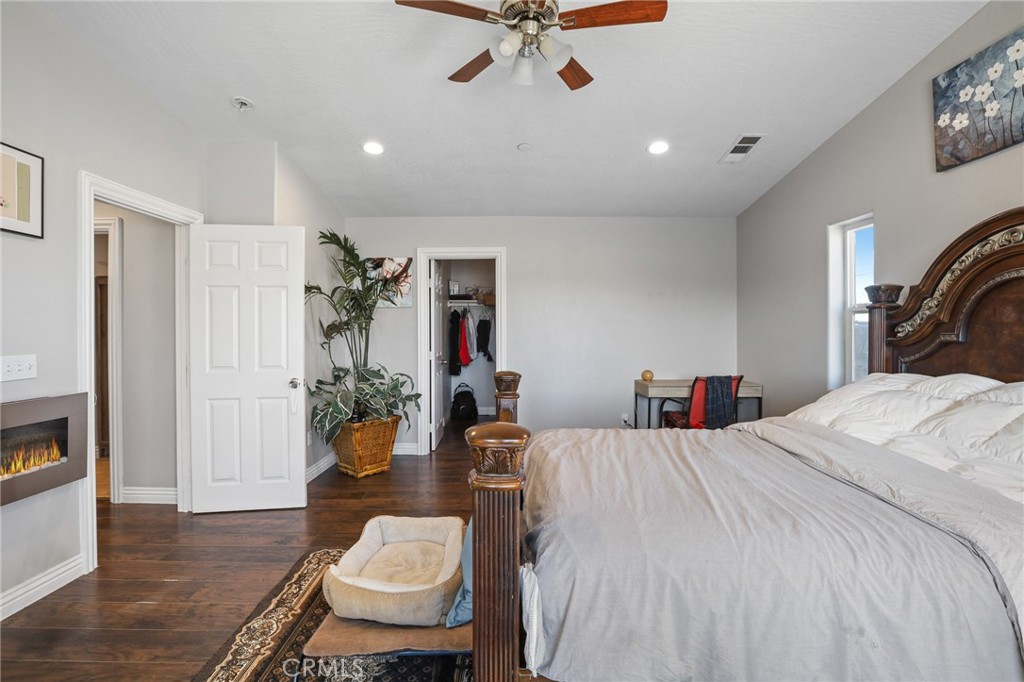 7755 7th Street Phelan, CA 92371 - Photo 18 of 27 a bed room with a bed and a chair