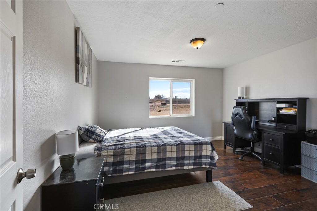 7755 7th Street Phelan, CA 92371 - Photo 20 of 27 a bedroom with a bed and a window