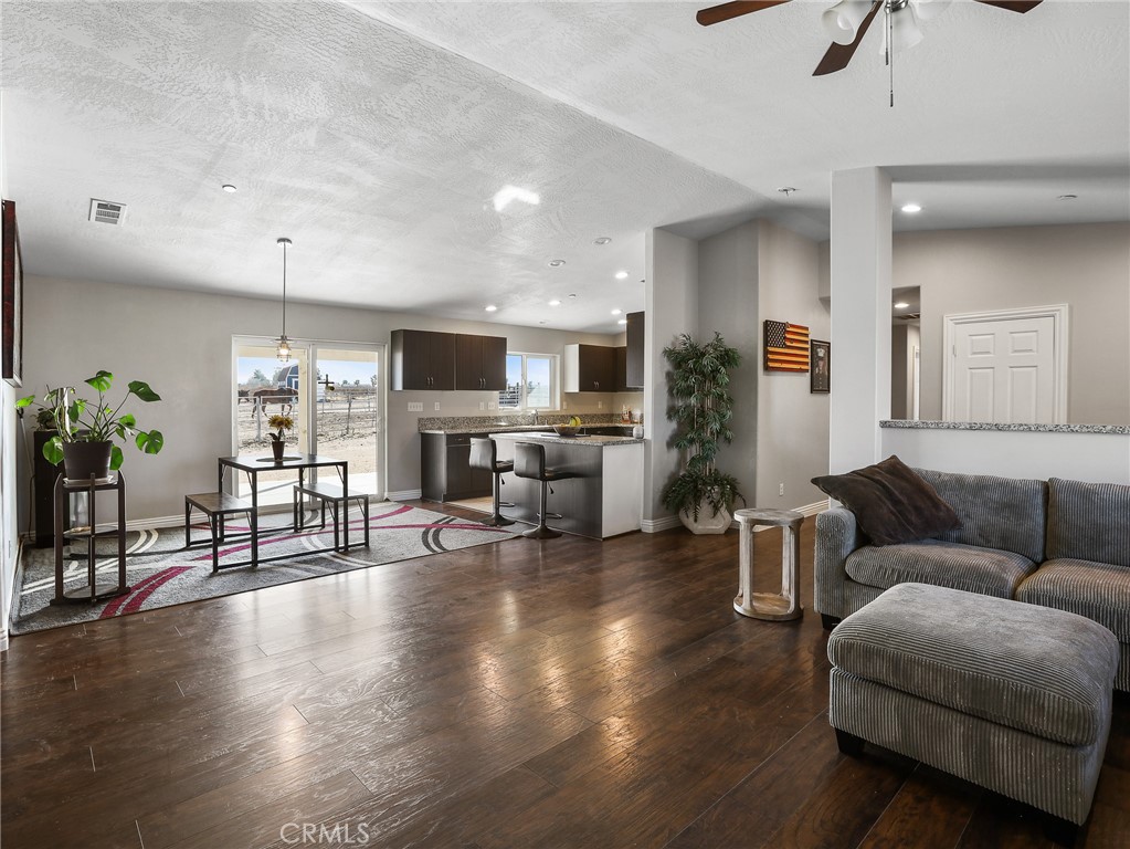 7755 7th Street Phelan, CA 92371 - Photo 3 of 27 a living room with furniture or wooden floor and a fireplace
