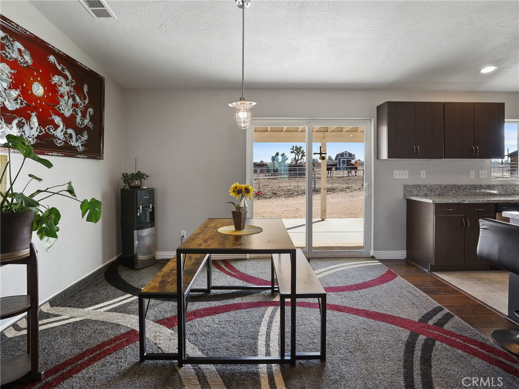 7755 7th Street Phelan, CA 92371 - Photo 9 of 27 a living room with furniture a flat screen tv and a floor to ceiling window