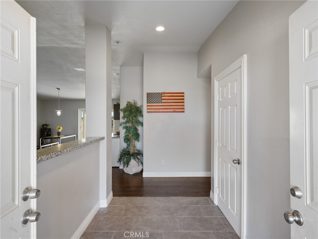 7755 7th Street Phelan, CA 92371 - Photo 10 of 27 a view of a hallway with wooden floor and a living room