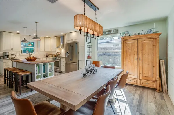 a kitchen with a refrigerator a sink and cabinets