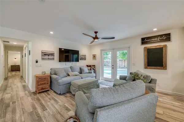 a spacious bedroom with a bed and a chandelier