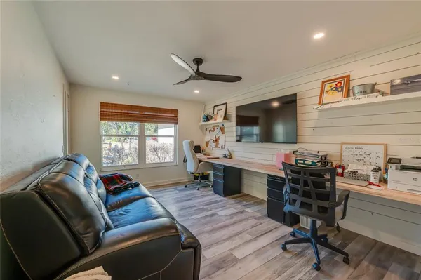 a living room with furniture kitchen view and a window