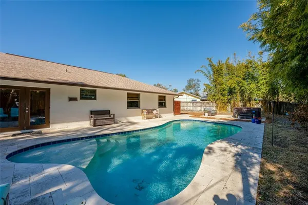 a view of a house with backyard porch and furniture