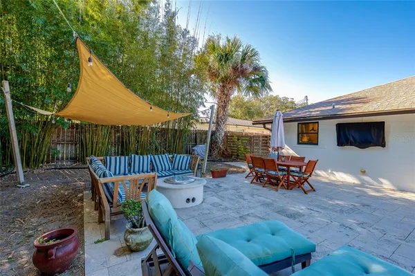 a view of a house with backyard and sitting area