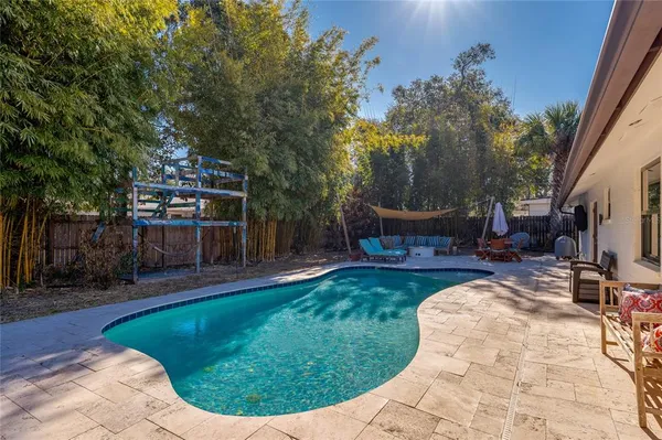 a view of a backyard with sitting area