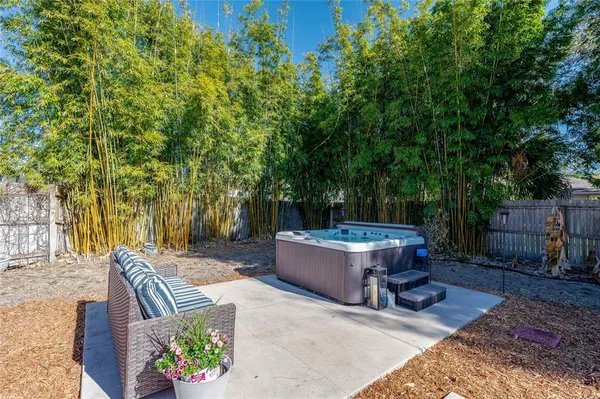 a view of backyard with outdoor seating a patio and plants