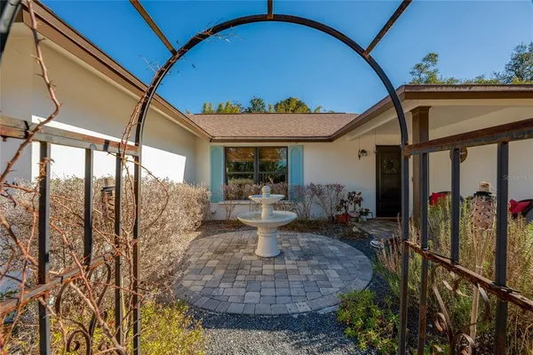 a backyard of a house with table and chairs