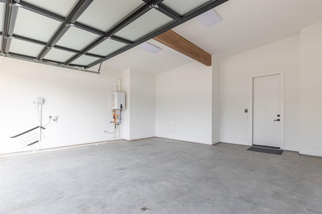 4202 Bonham Street Dallas, TX 75229 - Photo 32 of 32 Garage with baseboards and tankless water heater
