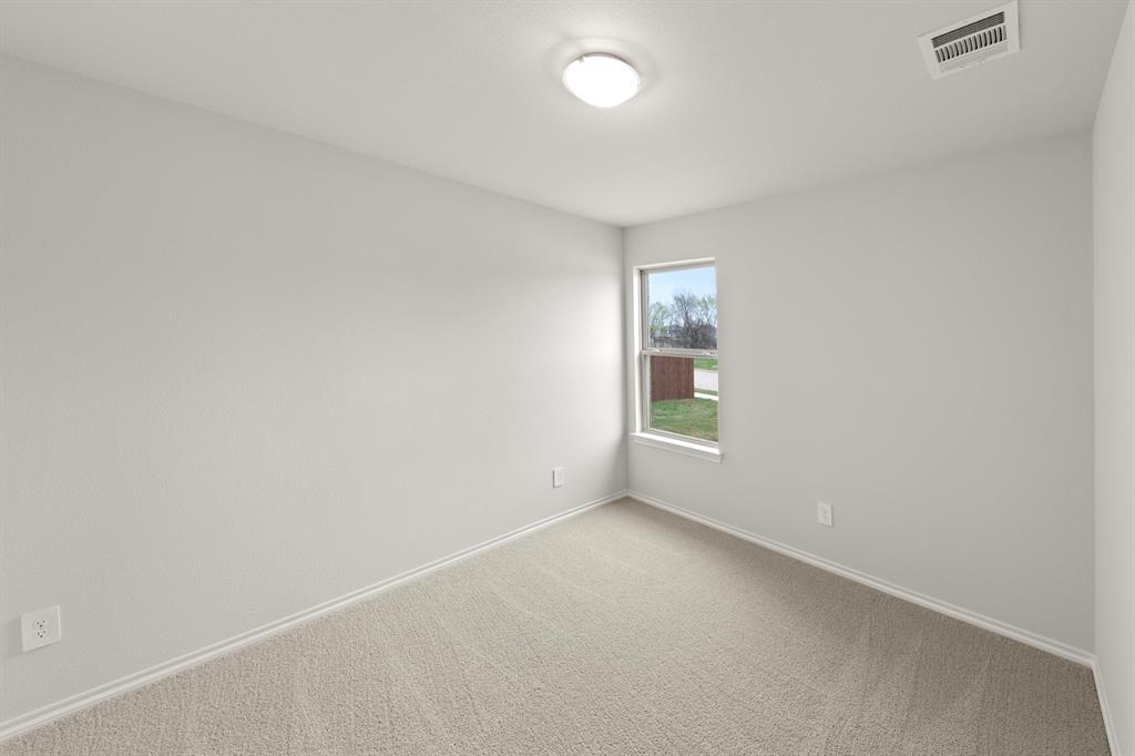 1120 Rushing Court Aubrey, TX 76227 - Photo 16 of 27 an empty room with windows