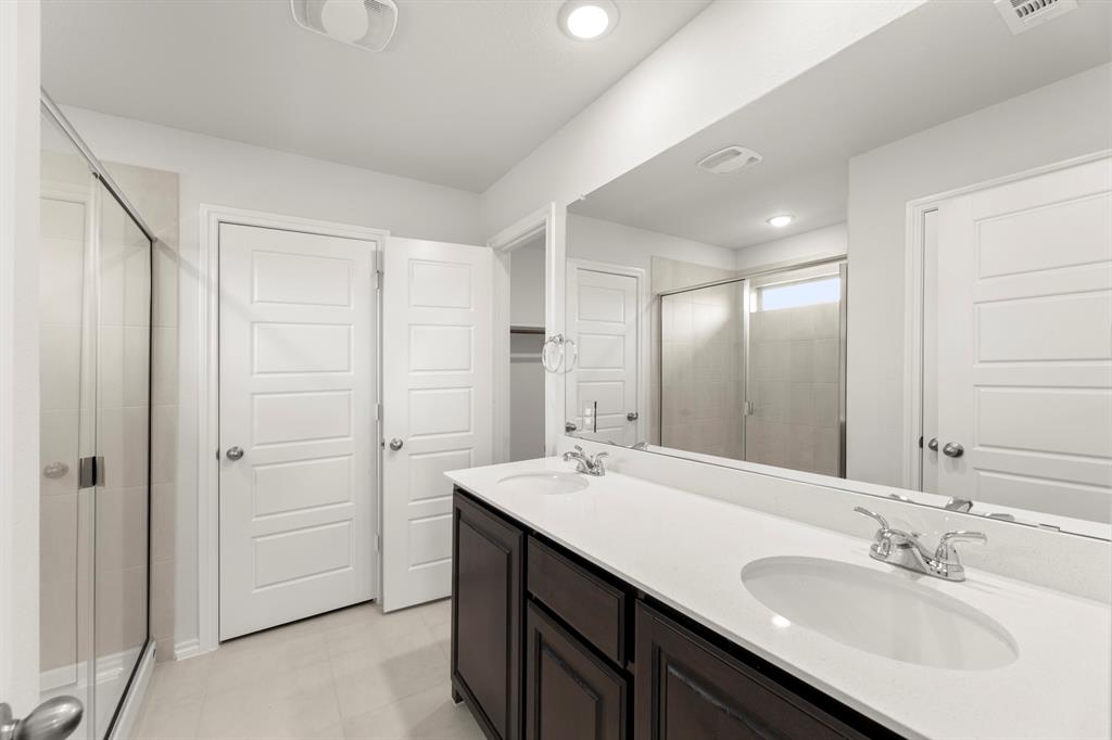 1120 Rushing Court Aubrey, TX 76227 - Photo 20 of 27 a bathroom with a double vanity sink a and a mirror