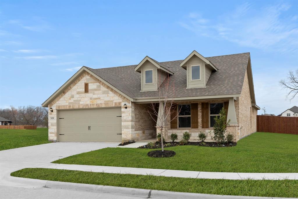 1120 Rushing Court Aubrey, TX 76227 - Photo 2 of 27 a front view of a house with a yard and garage