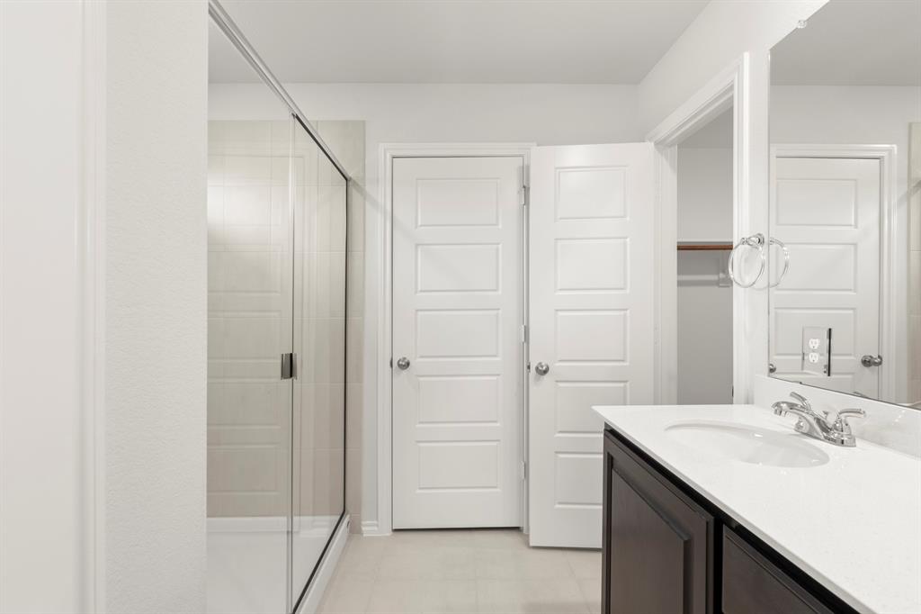 1120 Rushing Court Aubrey, TX 76227 - Photo 21 of 27 a bathroom with a granite countertop sink and a mirror