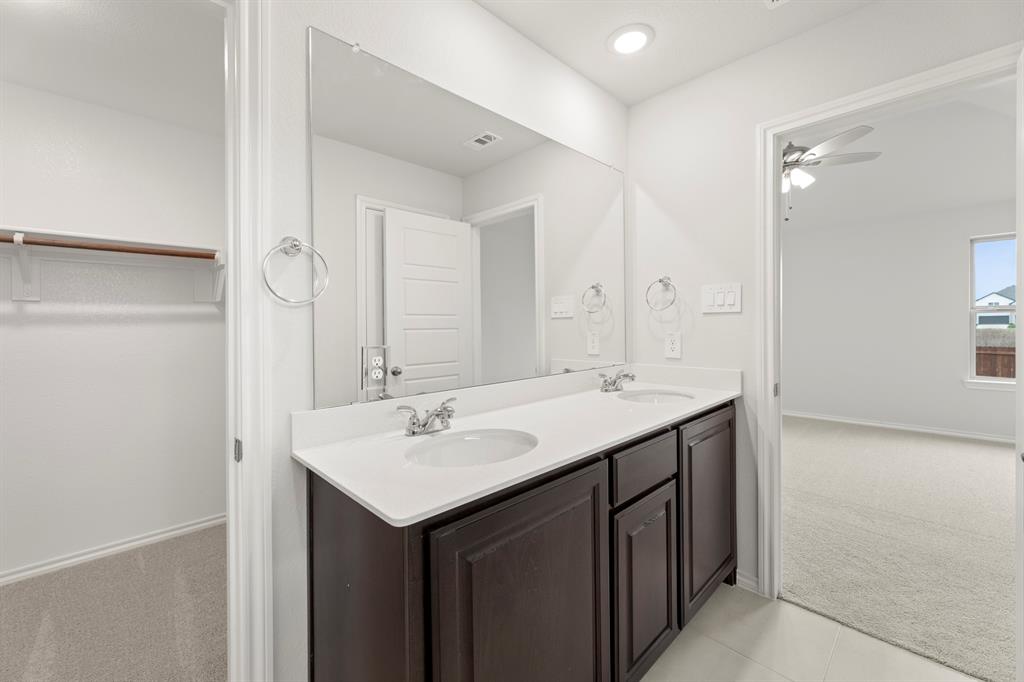 1120 Rushing Court Aubrey, TX 76227 - Photo 22 of 27 a bathroom with a sink and a mirror