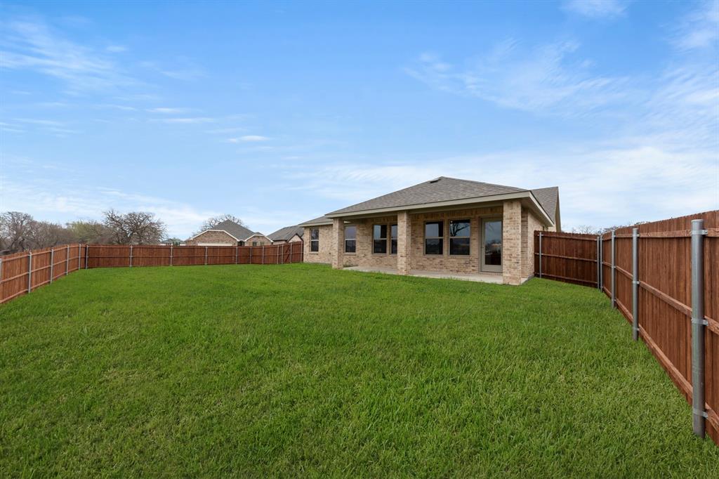 1120 Rushing Court Aubrey, TX 76227 - Photo 27 of 27 a front view of a house with garden