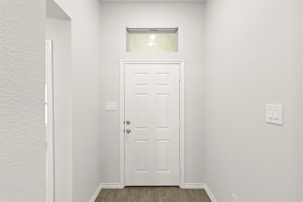 1120 Rushing Court Aubrey, TX 76227 - Photo 3 of 27 a view of a hallway with wooden floor